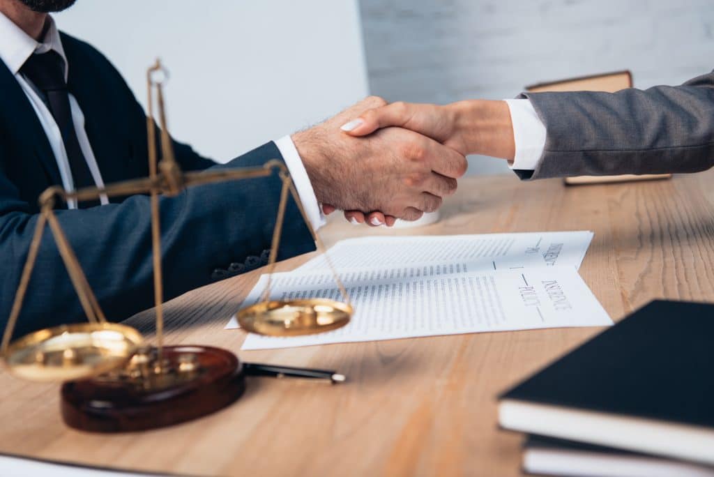 Client shaking hands with attorney