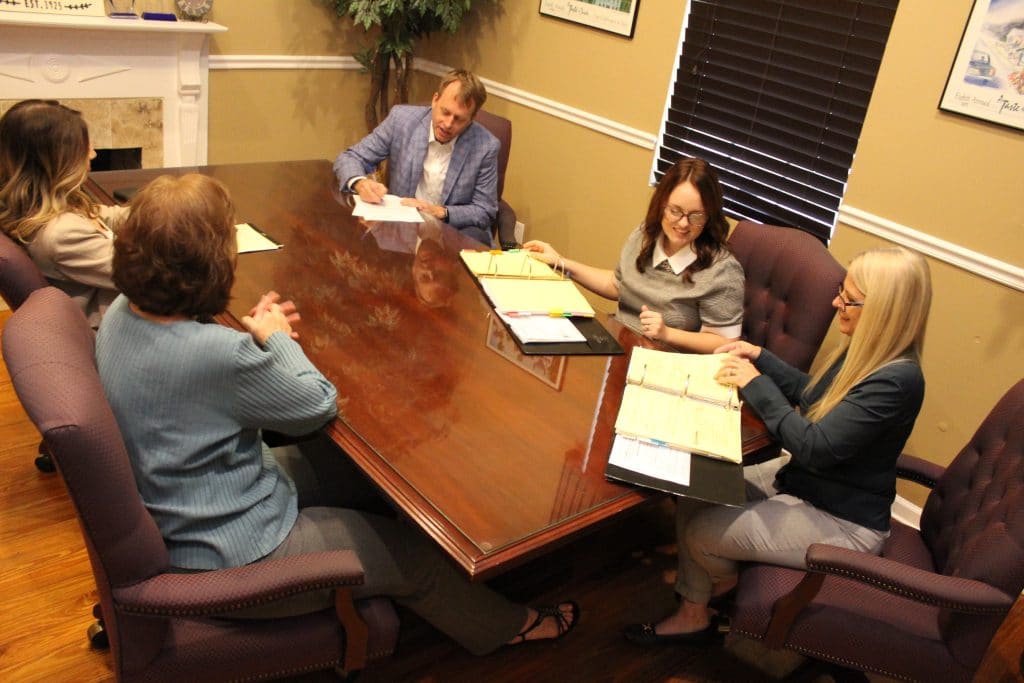 Jim Gordon and staff at conference table