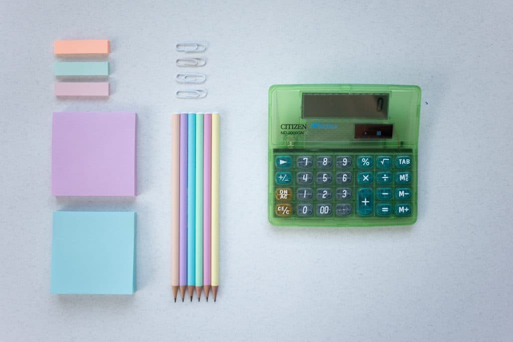 Flat lay of calculator and office supplies