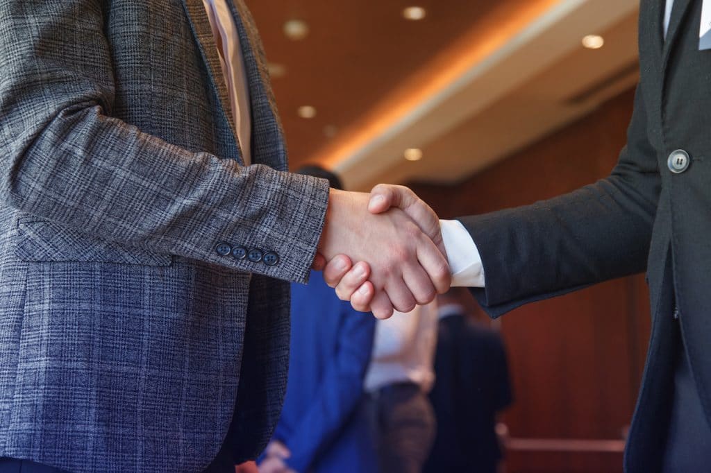 attorney shaking hands with his client