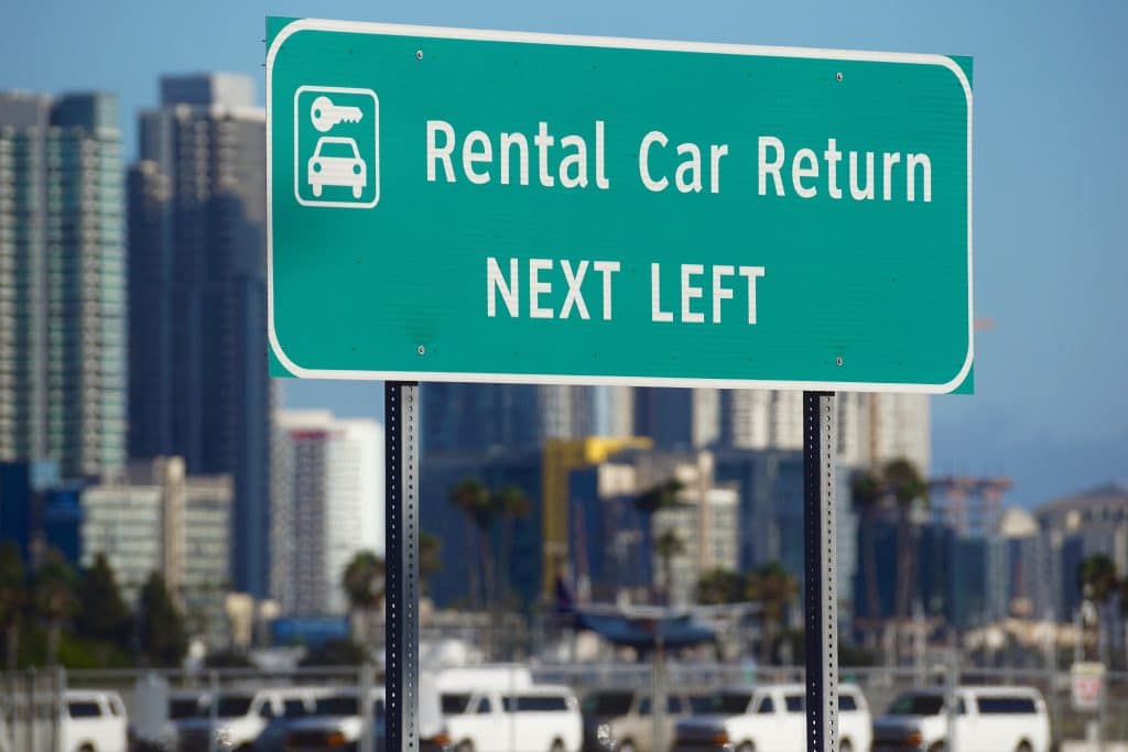 Rental car return sign near airport