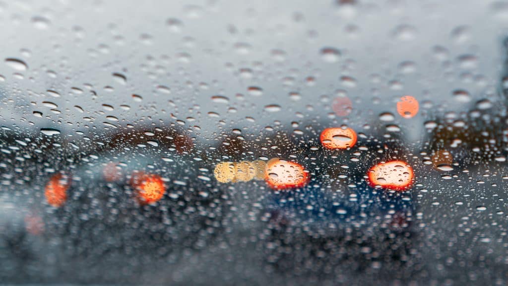 A windshield obscured by rain drops