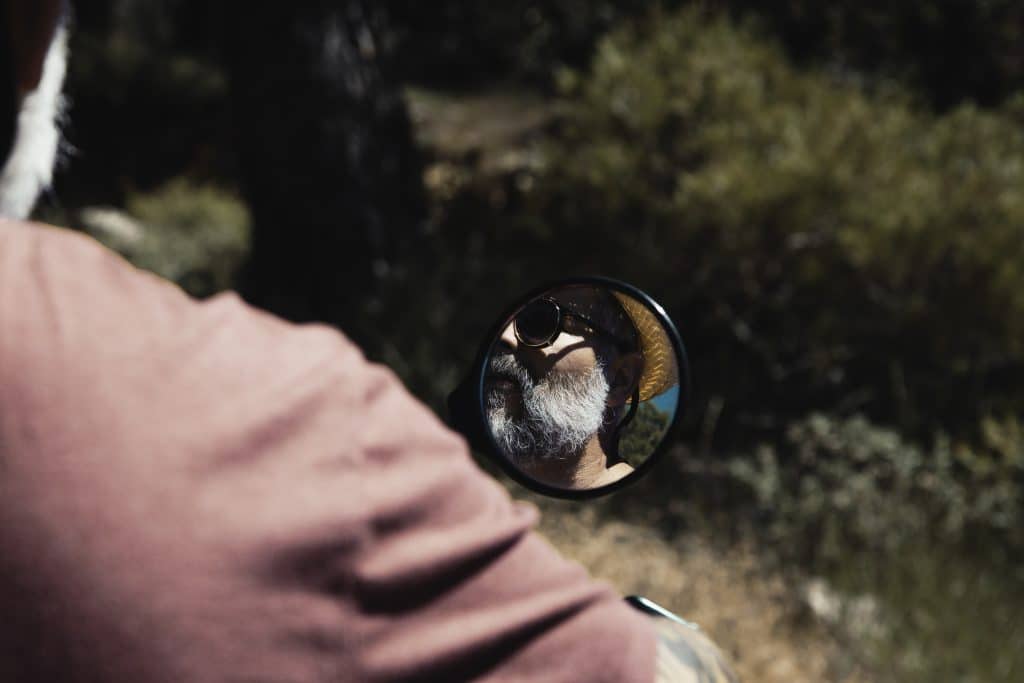 Reflection of rider displayed in motorcycle mirror