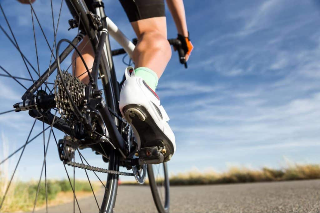 Close up view of cyclist on an open road from back wheel