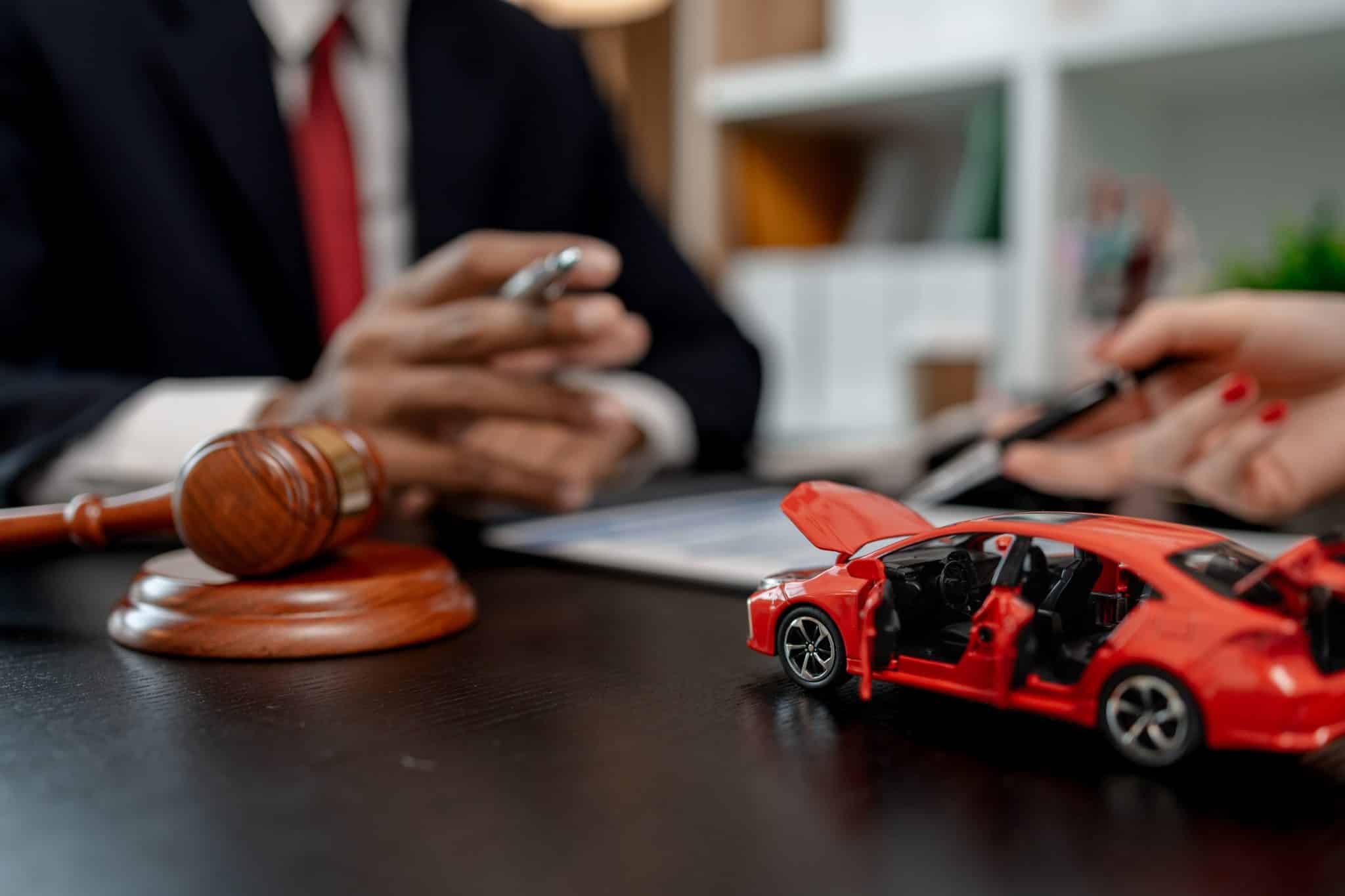 a lawyer is explaining the details of a car insurance policy to the car owner before she signs it, a lawyer explains to his client what will happen if she doesn't get car insurance