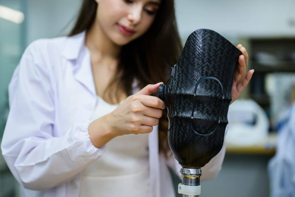 doctor adjusting prosthetic leg