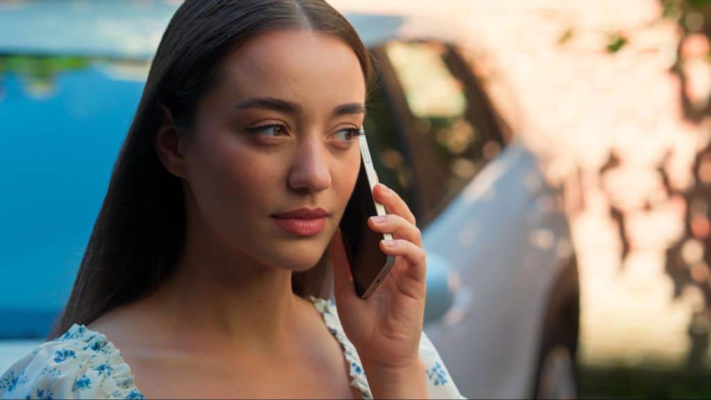 Woman using the phone after a call accident